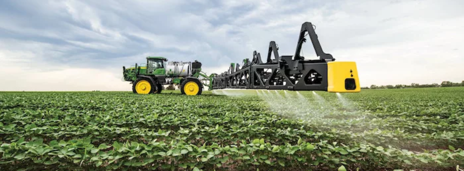 John Deere sprayer covering a field with precision ag technology.