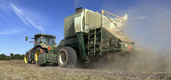Image of a peanut picker picking peanuts in a field.